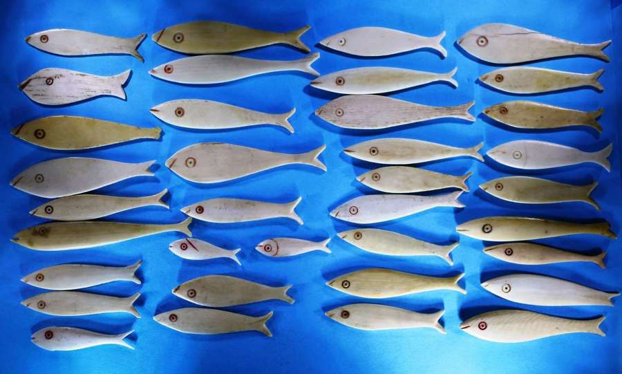 Group of 36 bone fish-shaped gaming counters